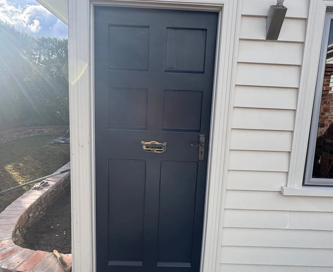 The same front door after being finished in a navy gloss paint