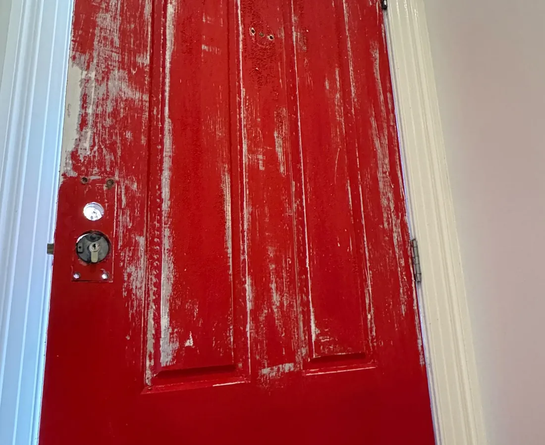 The same door stripped back and freshly coated in red