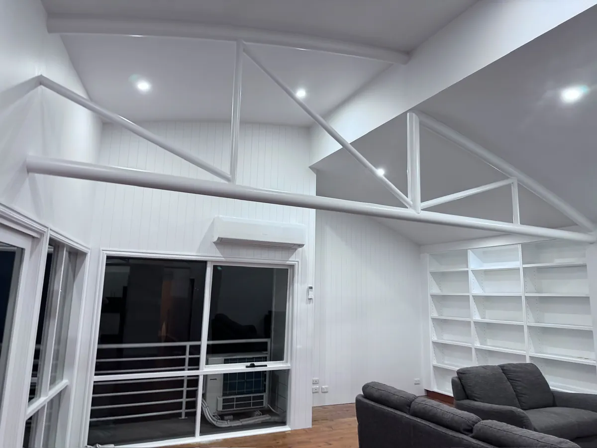 Freshly painted living space with full-height glass doors opening onto a deck