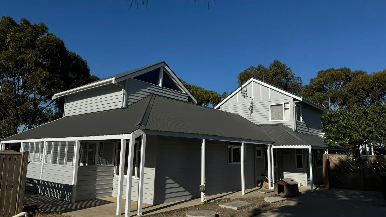 All Aces Painters tradesperson painting the exterior of a weatherboard home