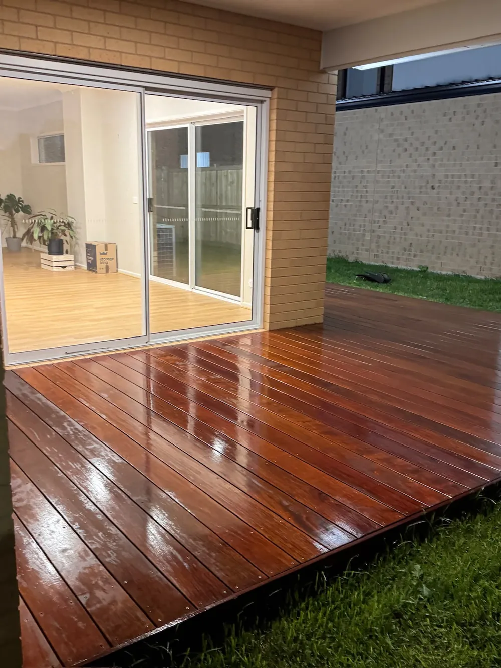 Repainted home exterior with timber deck and sliding doors