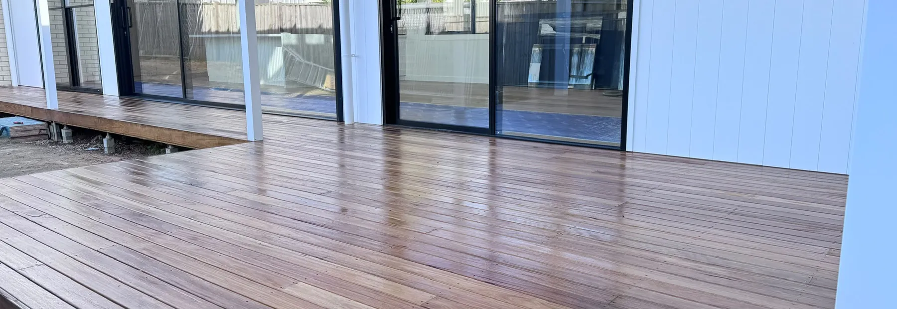 Freshly built timber deck and repainted exterior of an All Aces Painters project home